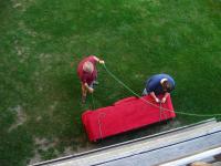 Lowering Cody's couch off their deck to get it into the moving van