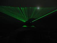 Long exposure of a green laser pointer beam sweeping through the air